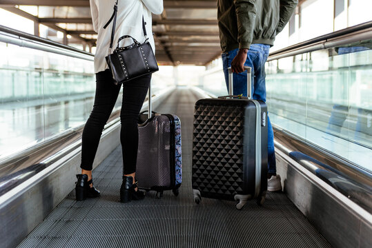 business woman and man walking with luggage at the airport