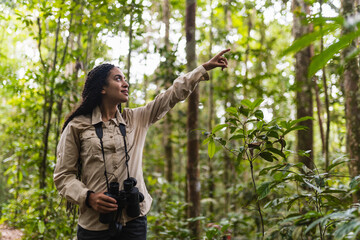 Girl in the Amazon jungle pointing upwards