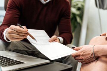 Anonymous business partners signing document on meeting