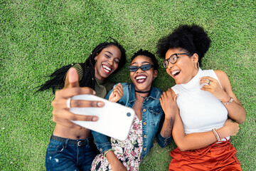 Three afro friends taking photo