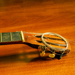 New strings for a six-string guitar are prepared.