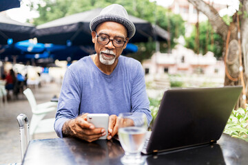 Senior black man using mobile phone.