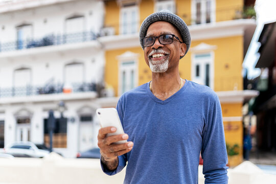 Senior black man using mobile phone.