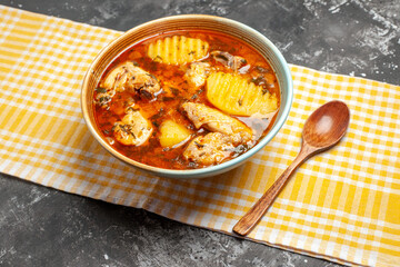 Horizontal view of fragrant soup with chicken and spoon