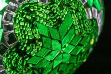Close-up of green mosaic lamp with star