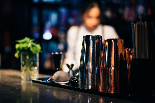 Shakers and cups on bar counter