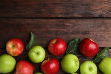 Fresh ripe apples on wooden table, flat lay. Space for text