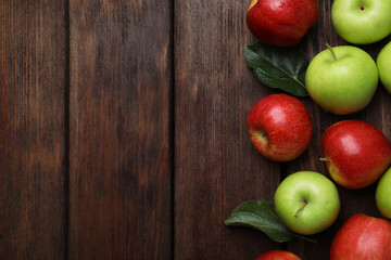 Fresh ripe apples on wooden table, flat lay. Space for text