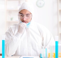 Fototapeta premium Young chemist student working in lab on chemicals