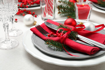 Festive table setting with beautiful dishware and Christmas decor on white background