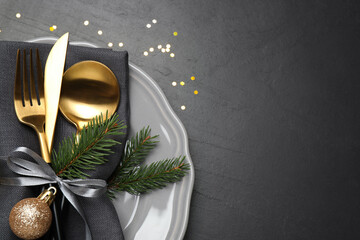 Festive table setting with beautiful dishware and Christmas decor on black background, top view. Space for text