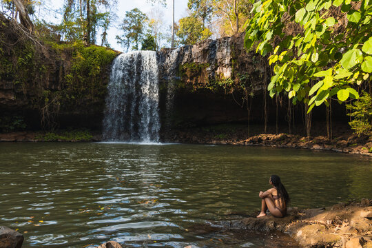 African girl enjoying a waterfall