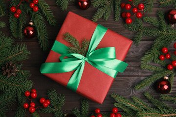 Flat lay composition with red Christmas gift box on wooden table