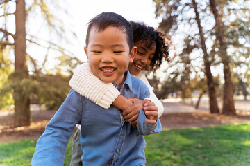 Multiethnic children hugging at the park.