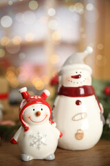 Decorative snowmen on wooden table, space for text