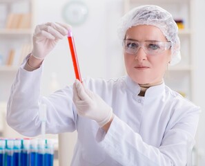 Woman doctor checking blood samples in lab