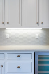 Modern kitchen details of granite counter and tile backsplash. 