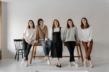 Smiling women look at the camera