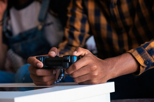 Unrecognizable friends playing video games