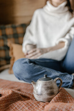 Teapot On A Blurry Woman's Background