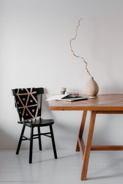 Minimalist interior with wooden table and black chair