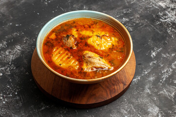 Top view of tasty chicken soupon cutting board