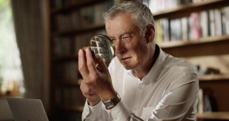 4k, Goldsmith examining precious stone with a magnifying glass