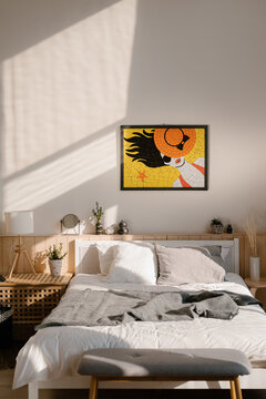 Bright mosaic hanging over bed in cozy bedroom