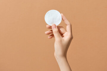 Woman's hand holding clean cotton pad