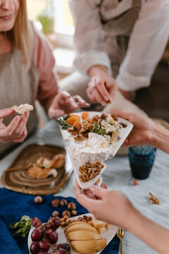 Anonymous women eating healthy snacks on party