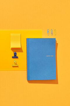 Notebook on yellow background, student accessories