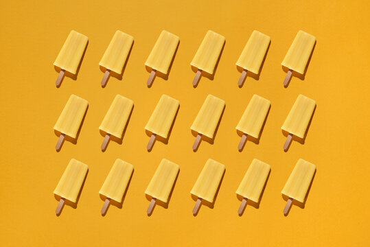 Yellow background with ice cream stick.