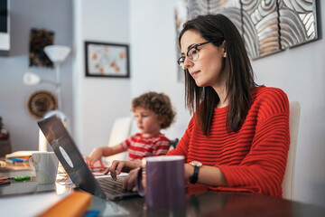 Mother and son sitting at a table. Family concept