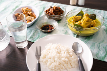 a plate of rice with many choice of indonesian side dishes for lunch or breakfast