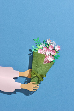 Woman hand holding flowers.