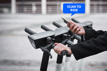 Woman hands with smartphone scanning the QR code to rent electric scooter 