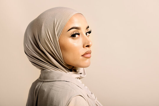 Portrait of Muslim Woman Over Beige Background