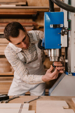 Carpenter putting drill on CNC machine