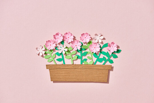 Flower in a pot paper cut on pink background