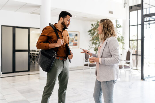 Two Coworkers Chatting in Office