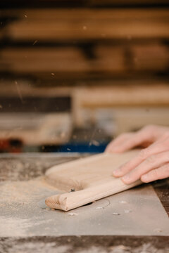 Crop carpenter grinding wooden board