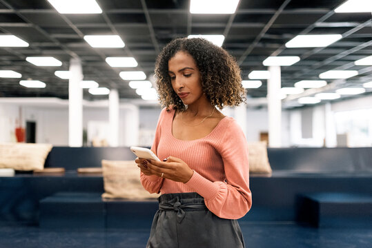 Curly Hair Business Woman Using Phone in Office