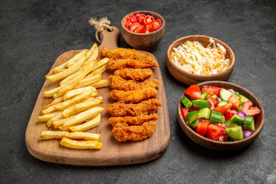 Side View Of Fried Chicken With Potatoes Different Spices And Sauerkraut With Salad On Dark Table