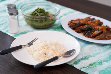 a plate of rice with many choice of indonesian side dishes for lunch or breakfast