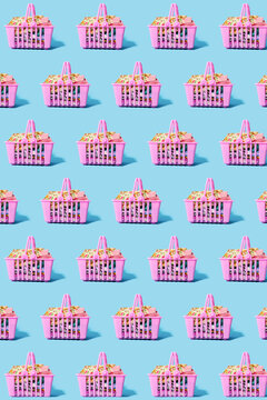 Pattern of pink shopping baskets filled with clothing