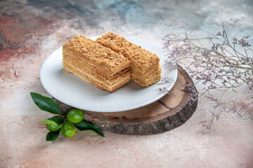 front view delicious cake slices honey cake on light background sweet pie biscuit cake