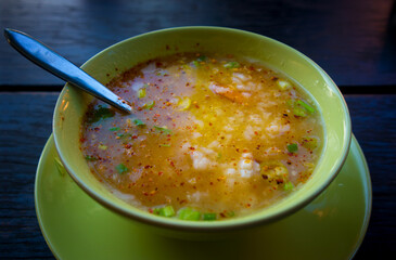 Thai rice soup in a green bowl