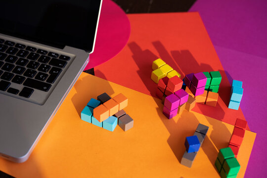 Laptop and colorful blocks on table at home