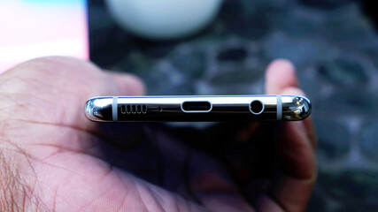 Closeup, usb charging port, Prise jack, speakers, microphone, on the bottom of a smartphone - 399417613