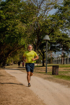 50 Year Old Man Jogging In The Park On A Beautiful Sunny Day